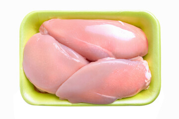 Green package of raw chicken fillet, isolated on a white background. Three halves of chicken breast in a package, top view