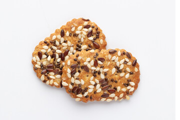 Tasty crackers with seeds on the white background.