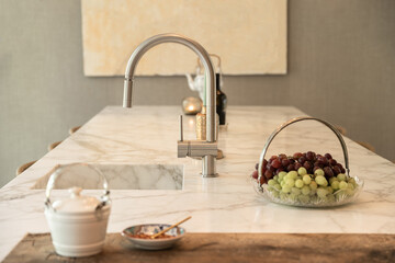 Built in sink with chrome tap and plate with grape