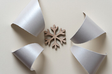 silver paper wedges with tails and wooden christmas snowflake decoration