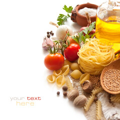 Pasta, vegetables, spices and oil on the table for Italian food