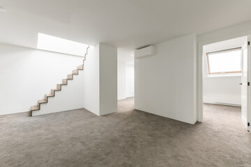 Empty basement space with white walls and concrete floor