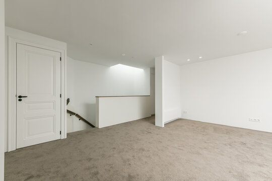 Empty basement space with white walls and concrete floor