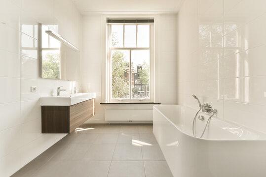 Bathroom with white walls and sink and toilet bowl