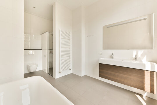 Bathroom with white walls and sink and toilet bowl