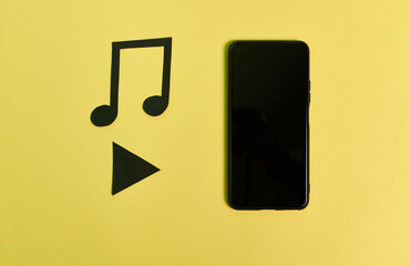 A play button, a telephone and musical notes on a yellow background