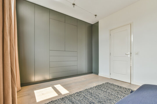 Built in gray wardrobe in light bedroom
