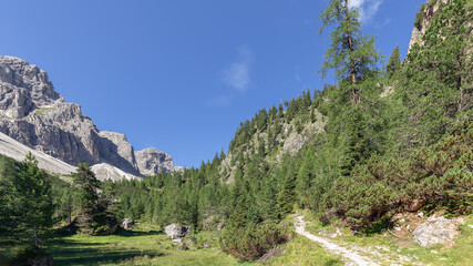 Scenic trail in the Dolomites gorge in the Italian Alps on a sunny day (Natural park Puez Odle)