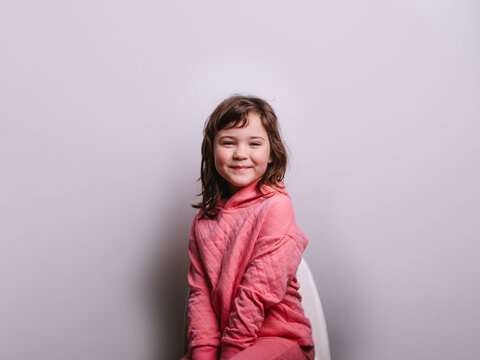 Cheerful girl against gray wall