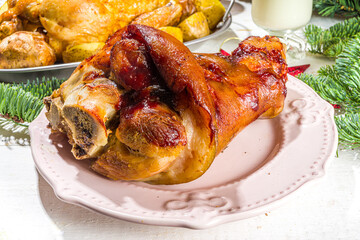 Festive Christmas dinner table with traditional foods and dished – baked ham, chicken, roasted carrots and brussels sprouts, potato, with Christmas decor and gifts 