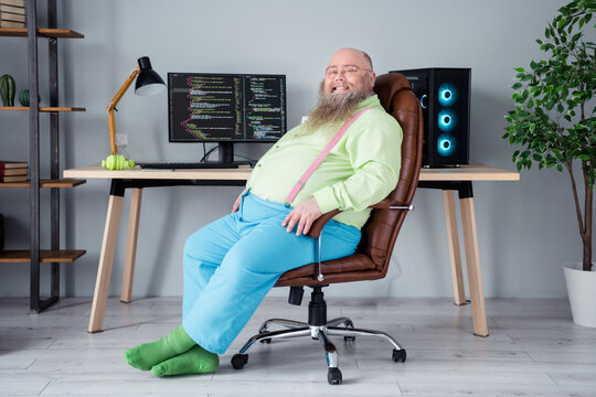 Photo of positive overweight guy sit chair computer screen code scripts finish work home office workplace