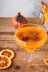 Pumpkin cocktail with cinnamon, orange juice and cocoa in glass mugs. Festive cocktail Halloween margarita. Pumpkin autumn drink for Halloween or Thanksgiving.