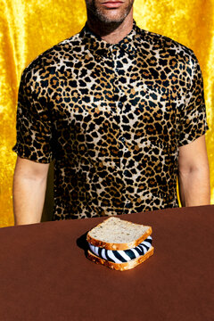 Faceless man near sandwich with zebra filling