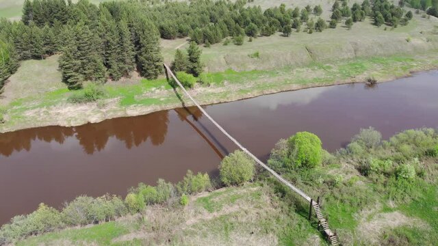Aerial view of the suspension pedestrian bridge (Strizhi, Kirov region, Russia)