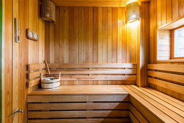 Fototapeta na wymiar interior of a classic Finnish sauna with a window and shelves made of natural wood