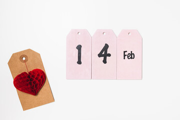 Price tag with red heart and text 14 Feb. Valentines Day gift shopping concept, holiday flat lay, copy space