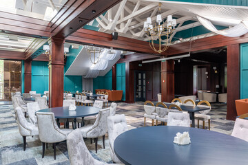 the interior of an expensive restaurant with huge beams under the wooden ceiling