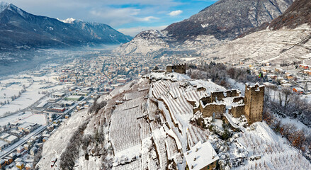 Castel Grumello and vineyards, near Sondrio in Valtellina, winter aerial view	