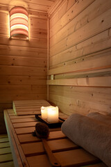 Interior of a small Finnish wooden sauna with sauna accessories.