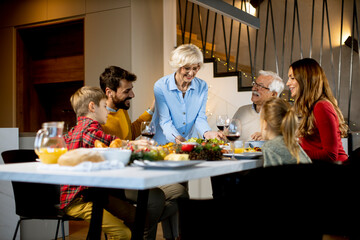 Happy family having dinner with red wine at home