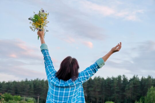 Woman With Her Back With Raised Arms With Bouquet Of Wild Flowers, Summer Nature