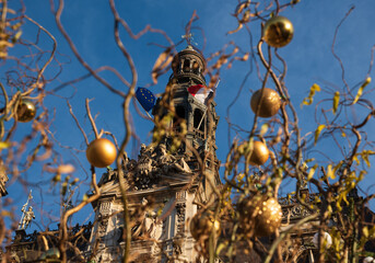 Fototapeta na wymiar Winter holidays in Paris. Hotel de Ville seen through blurry Christmas forest decoration. France.