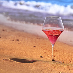 Wine glass with a cocktail by the sea.