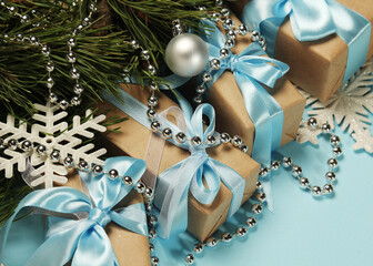 Gift boxes wrapped in craft paper with blue satin ribbons