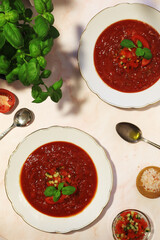 Plates with traditional gazpacho tomato soup
