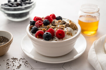 Bowl of muesli, granolla or oats with fresh berries, breakfast food.