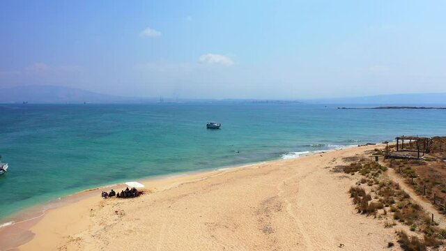Aerial Beautiful Shot Of Nautical Vessel In Sea, Drone Flying Backwards Over Beach Landscape - Tripoli, Lebanon