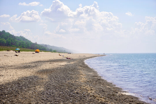 Indiana Dunes National Park Kemil Beach and Dunbar Beach area. Sunbathers on a rocky beach of Lake Michigan. 