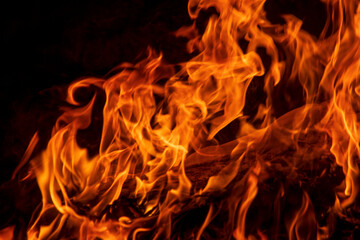 Abstract flame, fire flame texture, background. Blurred moving tongues of fire on a dark background.