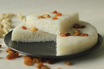 Vattayappam. Steamed rice cake made of sweet fermented batter of rice and coconut, topped with raisins while steaming. Traditional snack from south kerala