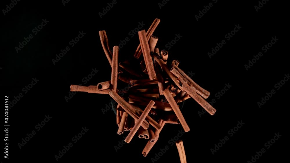 Poster Super slow motion of rotating cinnamon barks on black background. Ultimate realistic rotating motion. Filmed on high speed cinema camera, 1000fps.