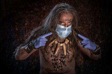 Primitive man wearing medical mask and rubber gloves against COVID 19
