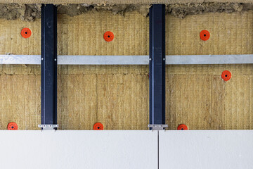Power saving technology: plates of mineral wool on the side wall, between the metal profiles for attaching the ventilated facade.