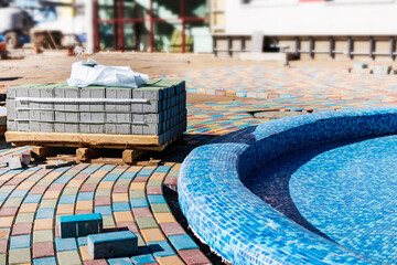 Industrial engineering. Professional tiling in the pool. Installation of blue ceramic pool tiles on...