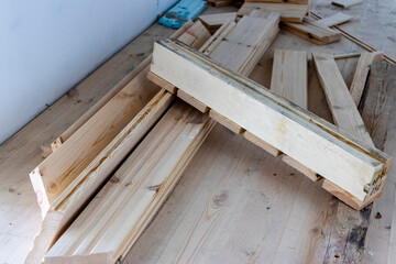 Installation of a wooden floor from boards. Partially completed floor. Natural materials in construction. Environmentally friendly floor.