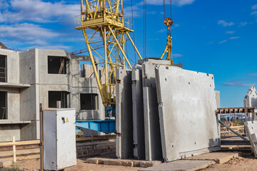 Many precast concrete wall panels are stocking in the storage area waiting for installation at...
