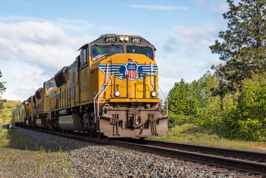 Mosier, OR, USA - May 01, 2018; Union Pacific train running along the south side of the Columbia Gorge in Oregon