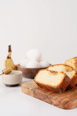 Front view of sliced banana bread on light concrete background