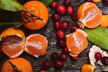 Above tabletop still life with tree ripened tangerines and whole raw cranberries - 474050534