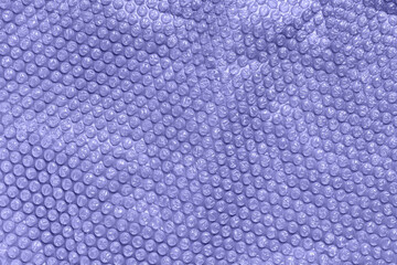 Color of the year 2022 very peri. Clear bubble foil for wrapping. Close up, texture background, trendy colors and pollution concept