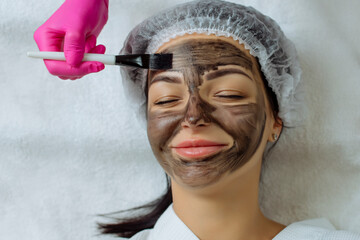 Close-up of carbon peeling procedure for middle-aged woman face. Laser pulses clean skin. Process...