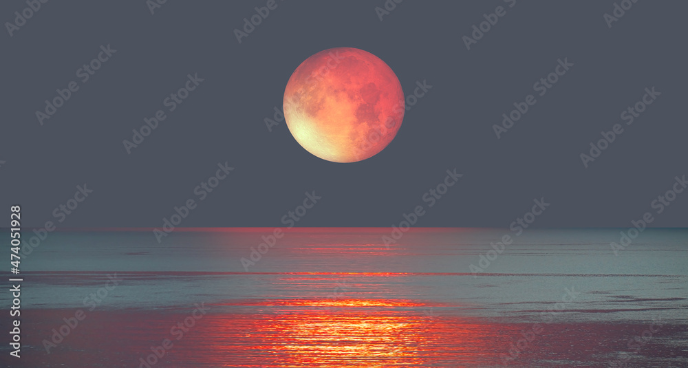 Poster lunar eclipse over the sea at sunset 