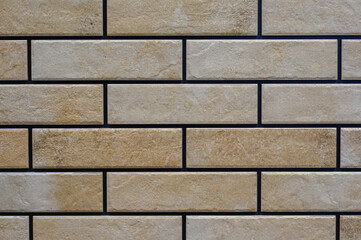 The texture of the tiles is in the form of a brick wall, there are scuffs, irregularities