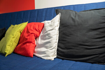 Colored pillows on a blue sofa, Living room furniture