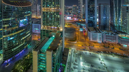 Fototapeta na wymiar Dubai international financial center skyscrapers aerial night timelapse.