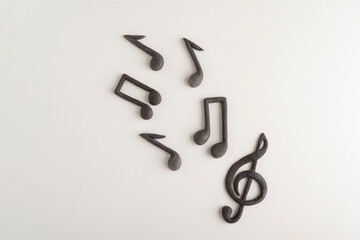 Chaotically arranged treble clef and notes on white background. Music symbol. Theme music.